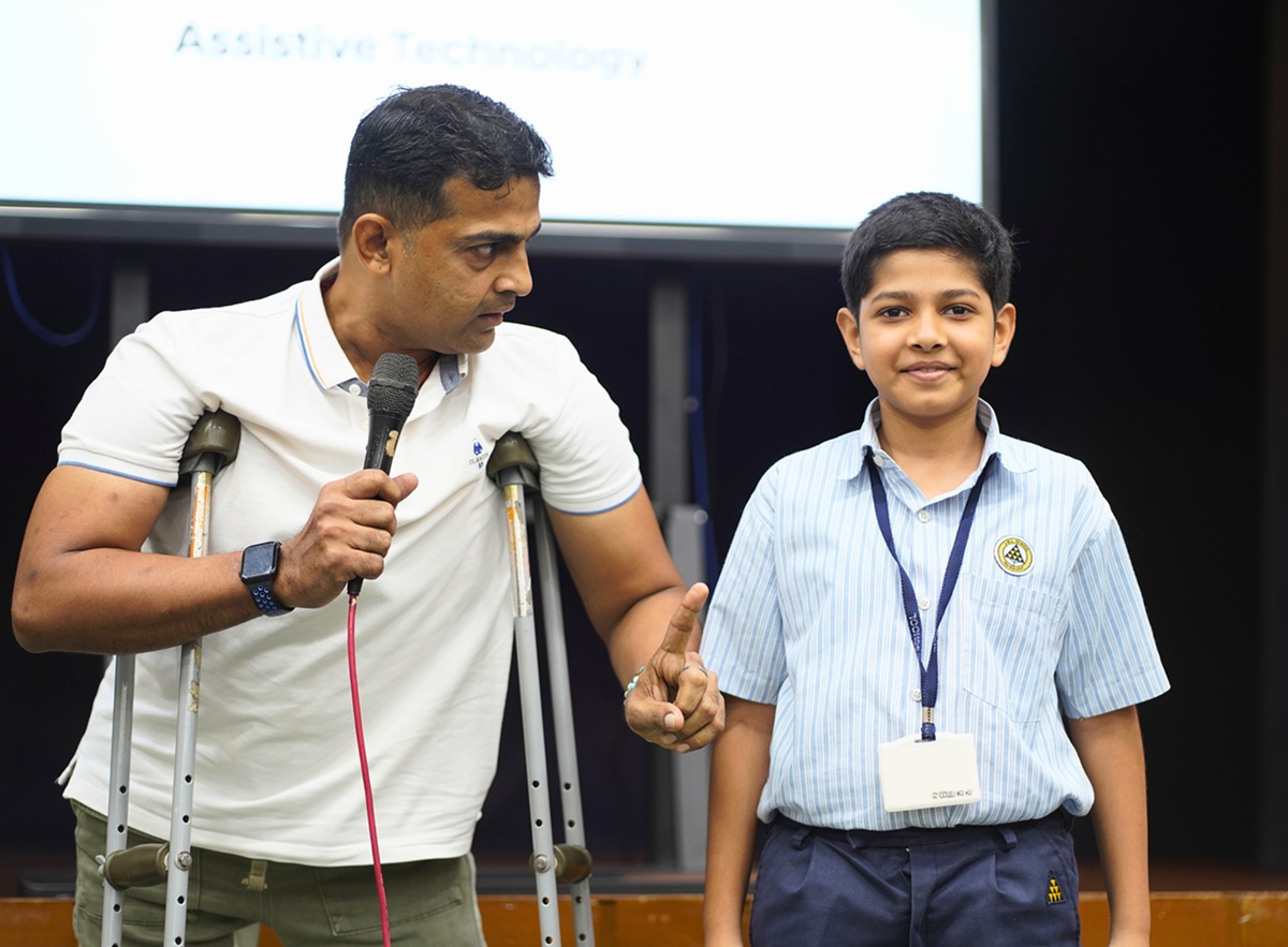 A student and a speaker sharing an assistive-technology session on stage