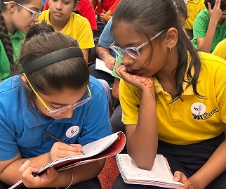 Students writing in notebooks